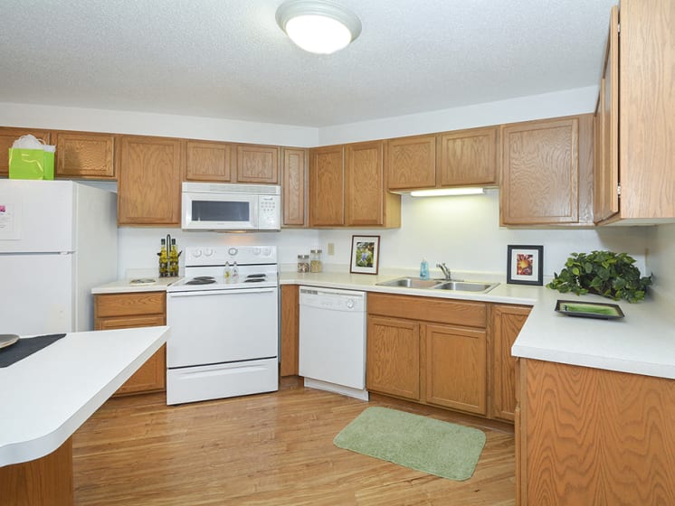 Fully-Equipped Kitchen with White Appliances and Wood Cabinets